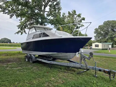 Trojan F-25 boat and ez ride trailer with titles to both!